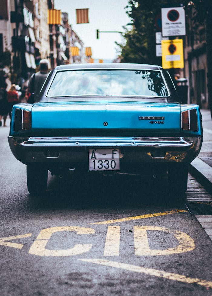 A classic Dodge vehicle parked on an urban street in Barcelona, showcasing vintage charm.